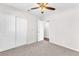 Bright bedroom features neutral paint, plush carpeting, and a ceiling fan for added comfort at 6770 Laronda Ln, Las Vegas, NV 89156