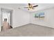 This carpeted bedroom offers a ceiling fan, window and neutral paint scheme at 6770 Laronda Ln, Las Vegas, NV 89156