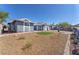 Street view of a home with desert landscaping and a small green patch in the front yard at 6770 Laronda Ln, Las Vegas, NV 89156