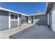 Home's exterior showcases a concrete patio area connecting the main structure with an adjacent door at 6770 Laronda Ln, Las Vegas, NV 89156