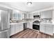 Renovated kitchen features stainless steel appliances, white countertops, and light gray cabinets at 6770 Laronda Ln, Las Vegas, NV 89156