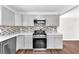 Renovated kitchen features stainless steel appliances, white countertops, and light gray cabinets at 6770 Laronda Ln, Las Vegas, NV 89156