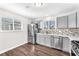 Updated kitchen boasts stainless steel appliances, light grey cabinets and designer backsplash at 6770 Laronda Ln, Las Vegas, NV 89156