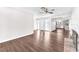 Living room featuring hardwood floors, a fireplace, a decorative front door, and an open view into the kitchen at 6770 Laronda Ln, Las Vegas, NV 89156