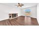 Bright living room features hardwood floors, fireplace, and a sliding door that gives access to the backyard at 6770 Laronda Ln, Las Vegas, NV 89156