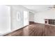 Spacious living room featuring hardwood floors, a brick fireplace, and a decorative front door at 6770 Laronda Ln, Las Vegas, NV 89156