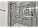 Modern walk-in shower boasts attractive tile and sleek hardware for a luxurious feel at 6770 Laronda Ln, Las Vegas, NV 89156