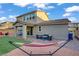 Relax in this landscaped backyard oasis, featuring a covered patio, vibrant hammock, and low-maintenance artificial lawn at 10290 Lodge Pine Ave, Las Vegas, NV 89166