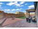 A beautiful backyard, complete with artificial grass, decorative rock, a paver patio and a relaxing hammock at 10290 Lodge Pine Ave, Las Vegas, NV 89166