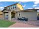 A charming covered patio extends to a backyard with synthetic lawn and a cozy outdoor seating area at 10290 Lodge Pine Ave, Las Vegas, NV 89166