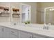Bathroom with dual sinks, white cabinets, decor, and a large mirror at 10290 Lodge Pine Ave, Las Vegas, NV 89166