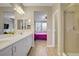 Spacious bathroom featuring dual sinks, modern lighting, and a glass-enclosed shower at 10290 Lodge Pine Ave, Las Vegas, NV 89166