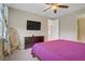 Comfortable bedroom with ceiling fan, TV, walk-in access, and natural light at 10290 Lodge Pine Ave, Las Vegas, NV 89166