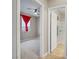 Bedroom featuring carpet, ceiling fan, and red curtains with an adjoining bathroom at 10290 Lodge Pine Ave, Las Vegas, NV 89166