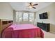 Bedroom with a headboard, TV and dresser, and a window with curtains at 10290 Lodge Pine Ave, Las Vegas, NV 89166