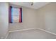 Carpeted room featuring a window, ceiling fan and neutral paint at 10290 Lodge Pine Ave, Las Vegas, NV 89166