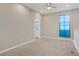 Bright bedroom with neutral walls, carpeted floors, ceiling fan, and a view of the bathroom at 10290 Lodge Pine Ave, Las Vegas, NV 89166
