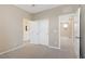 Carpeted room with white closet doors and view of the adjacent bathroom at 10290 Lodge Pine Ave, Las Vegas, NV 89166