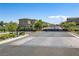 View of the community gate with manicured landscaping welcoming residents and guests at 10290 Lodge Pine Ave, Las Vegas, NV 89166
