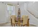 Dining area with a wood table, light wood floors, natural light from the window, and stairway access at 10290 Lodge Pine Ave, Las Vegas, NV 89166