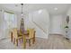 Dining area with a wooden table and chairs, light wood floors, and stairway access at 10290 Lodge Pine Ave, Las Vegas, NV 89166