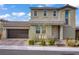 Two-story home featuring an attached two car garage, desert landscaping, and tile roof at 10290 Lodge Pine Ave, Las Vegas, NV 89166