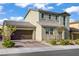 Charming home featuring a paved driveway, a two-car garage, and well-maintained landscaping at 10290 Lodge Pine Ave, Las Vegas, NV 89166