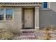 Inviting front door is enhanced by a decorative brick walkway and well-maintained landscaping at 10290 Lodge Pine Ave, Las Vegas, NV 89166