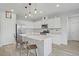 Bright kitchen featuring an island with seating, stainless steel appliances, and white cabinetry at 10290 Lodge Pine Ave, Las Vegas, NV 89166
