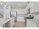 Contemporary kitchen with stainless steel appliances, white cabinets and countertops, and an island at 10290 Lodge Pine Ave, Las Vegas, NV 89166