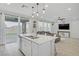 Bright kitchen with stainless steel appliances, island and sliding glass doors to a backyard at 10290 Lodge Pine Ave, Las Vegas, NV 89166