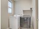 Well-lit laundry room featuring a new washer and dryer set with a small window at 10290 Lodge Pine Ave, Las Vegas, NV 89166