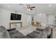 Cozy living room with a large leather sofa, mounted TV, and dining area nearby at 10290 Lodge Pine Ave, Las Vegas, NV 89166