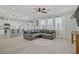 Bright living room with hardwood flooring, leather sofa, and sliding doors to the backyard at 10290 Lodge Pine Ave, Las Vegas, NV 89166
