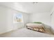 Well-lit bedroom showcasing a neutral color palette, a large window, and plush carpeting at 1101 Willow Tree Dr # D, Las Vegas, NV 89128