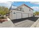 Exterior of property showcasing garages and a second-story balcony with black metal railings at 1101 Willow Tree Dr # D, Las Vegas, NV 89128