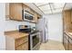 Well-maintained kitchen features stainless steel appliances, wood cabinets, and functional layout at 1101 Willow Tree Dr # D, Las Vegas, NV 89128