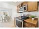 Bright kitchen featuring wood cabinets, stainless steel appliances, and an adjacent dining area at 1101 Willow Tree Dr # D, Las Vegas, NV 89128