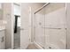Bathroom shower featuring tiled walls, a glass door, and metal fixtures at 11236 Rainbow Peak Ave # 210, Las Vegas, NV 89135