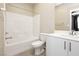 Bathroom featuring a bathtub, shower, toilet, sink, and vanity with white tiling at 11236 Rainbow Peak Ave # 210, Las Vegas, NV 89135