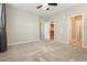 Neutral bedroom features a ceiling fan, plush carpet, walk-in closet and multiple doors at 11236 Rainbow Peak Ave # 210, Las Vegas, NV 89135