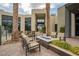 Community courtyard with a fire pit, comfortable seating, and lush landscaping at 11236 Rainbow Peak Ave # 210, Las Vegas, NV 89135