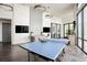 Spacious game room with ping pong table, pendant lights, and modern design at 11236 Rainbow Peak Ave # 210, Las Vegas, NV 89135