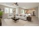 Bright, open-concept living room featuring modern furniture, neutral tones, and seamless flow into the kitchen at 11236 Rainbow Peak Ave # 210, Las Vegas, NV 89135