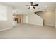 Bright living area showcasing the transition to the kitchen and stairs in a neutral, open layout at 11236 Rainbow Peak Ave # 210, Las Vegas, NV 89135