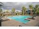 Relaxing community pool area featuring palm trees and comfortable lounge chairs for residents' enjoyment at 11236 Rainbow Peak Ave # 210, Las Vegas, NV 89135