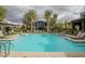 Community pool with inviting, sparkling water, poolside lounge chairs, and lush landscaping for relaxation at 11236 Rainbow Peak Ave # 210, Las Vegas, NV 89135