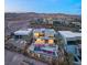 Modern home with a beautiful backyard pool and desert mountain views at twilight in a gated community at 12 Falling Canyon Ct, Henderson, NV 89011