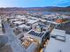 Aerial twilight view of a neighborhood with modern homes featuring solar panels in a lakeside community at 12 Falling Canyon Ct, Henderson, NV 89011