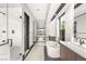 Modern bathroom featuring a soaking tub, dual vanities, and a glass-enclosed shower at 12 Falling Canyon Ct, Henderson, NV 89011